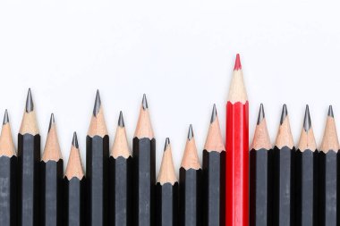 Red pencil standing out from crowd of plenty identical fellows clipart