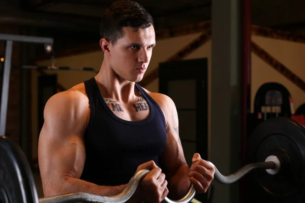 Sporty young man work out biceps