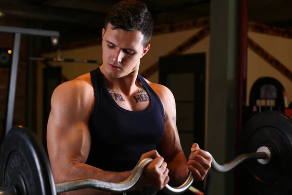 Sporty young man work out biceps