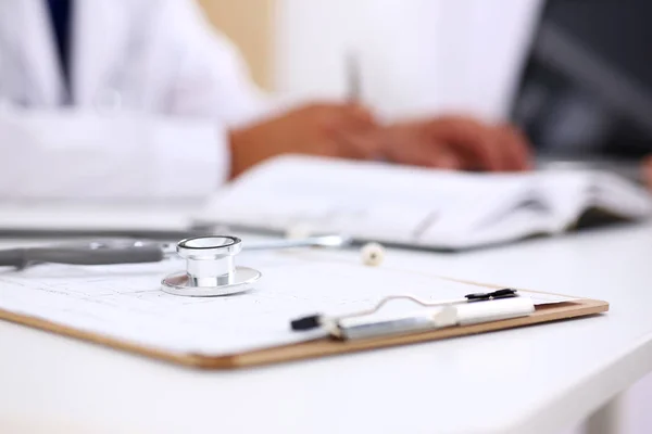 Stethoscope head lying on medical forms closeup — Stock Photo, Image