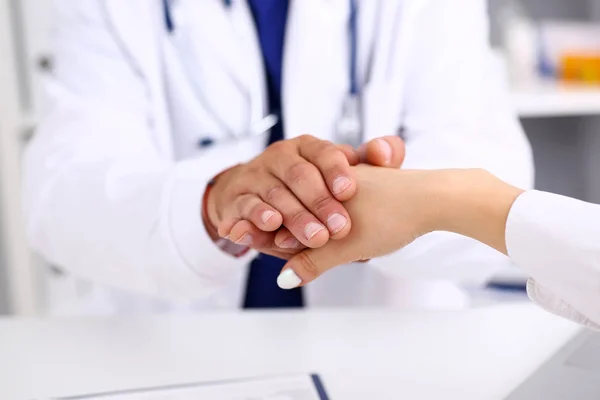 Příjemný lékař drží ženská ruka v úřadu — Stock fotografie
