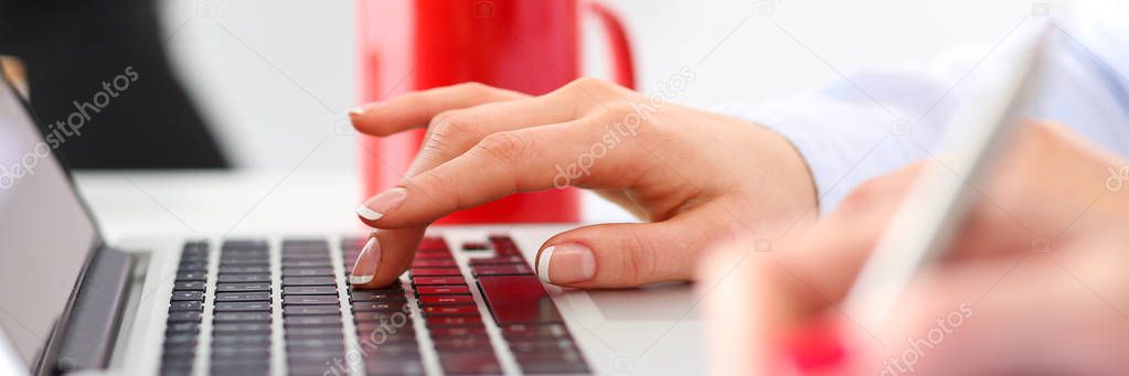 Hand of businesswoman press button at laptop computer