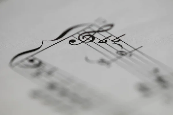 Musical notes printed on paper sheet — Stock Photo, Image