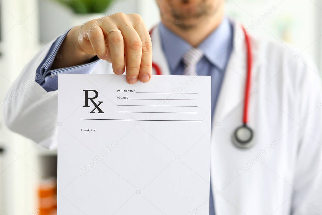 Male medicine doctor hand hold and give prescription form to patient
