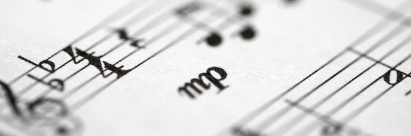Musical notes printed on paper sheet — Stock Photo, Image