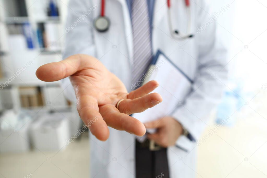 Male medicine doctor offering helping hand closeup