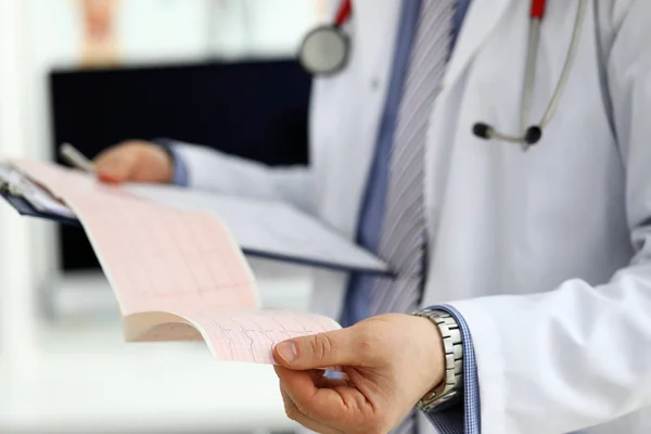 Male medicine doctor hands holding cardiogram chart — Stock Photo, Image