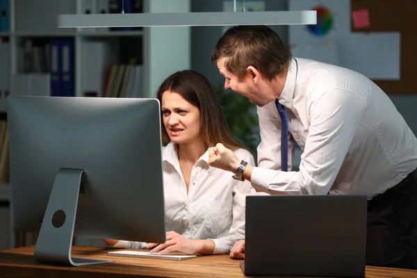 Man in the office is angry and shouts at the woman