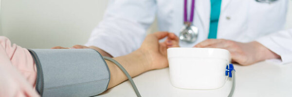 Hand of doctor and patient while pressure measuring