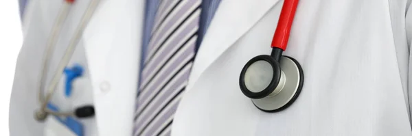 Stethoscope lying on male therapeutist doctor chest — Stock Photo, Image