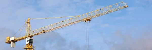 Big hoisting crane standing at blue sky