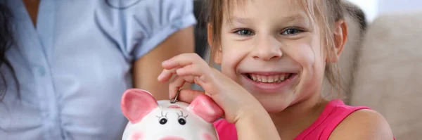 Niño poniendo moneda en caja de ahorro — Foto de Stock