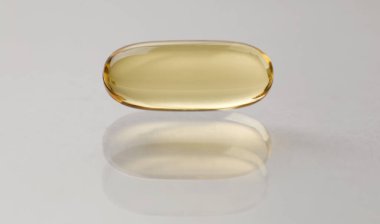 Source vitamins fish oil capsule lies on surface
