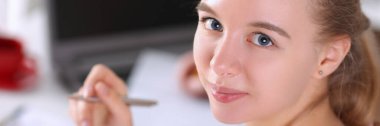 Cute woman writing report