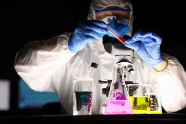 Chemical laboratory, man conducts an experiment