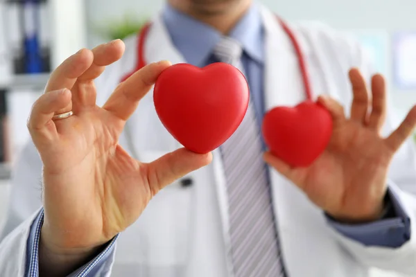 GP showing two red hearts in camera close-up — Stockfoto