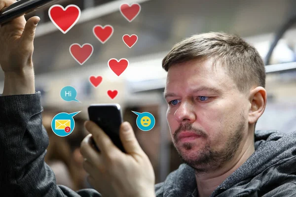 Handsome man in subway using dating apps — 图库照片