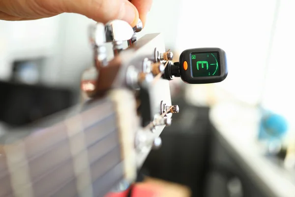 Tuner is installed on guitar neck for tuning notes — Stock Photo, Image