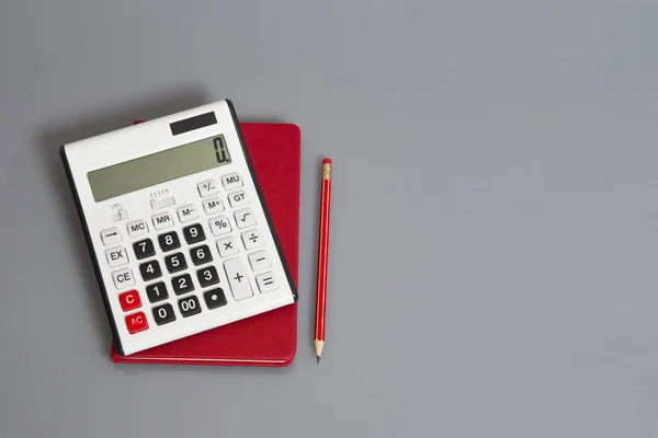 Calculator and red pencil on desk — Stock Photo, Image