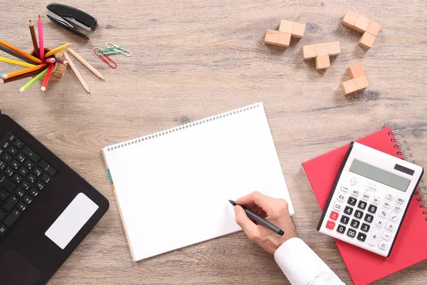 Man writing note at the blank notebook on the office desk — Stock Photo, Image