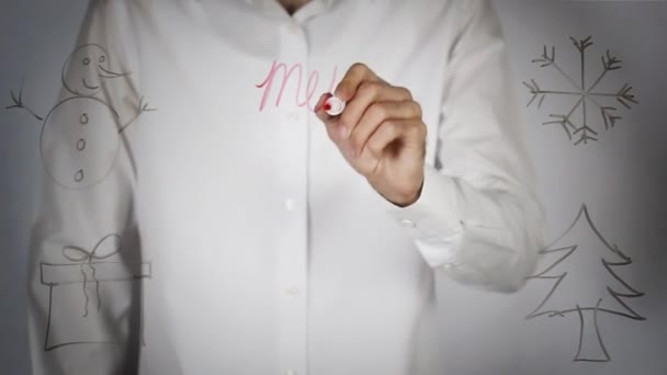 Hombre escribiendo "Feliz Navidad" en pantalla transparente con adorno de Navidad — Vídeos de Stock