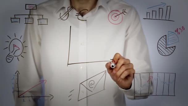 Man writing 2018 plan and graphic on transparent screen — Stock Video