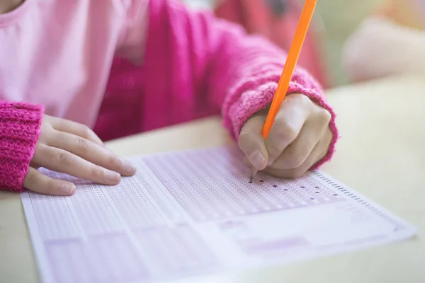 Niño está marcando forma óptica en el examen — Foto de Stock