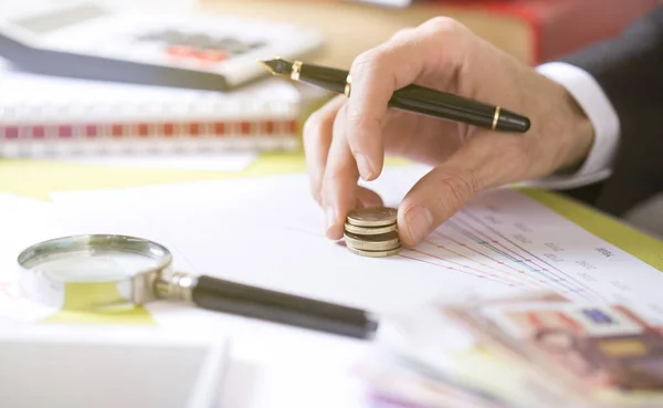 Man hand puts money on the increase chart — Stock Photo, Image