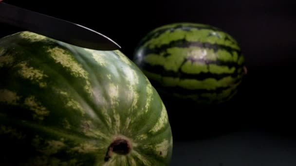 Watermelon with knife and black background — Stock Video