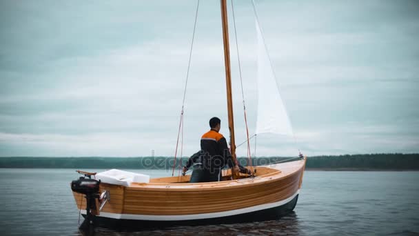Holzsegelboot mit zwei Männern, die Mast setzen wollen — Stockvideo