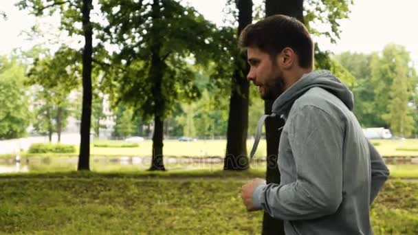 Hombre corriendo en el verde parque de verano — Vídeos de Stock