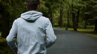 Dışarıda genç yakışıklı atlet sonbahar doğa Park telefon ile