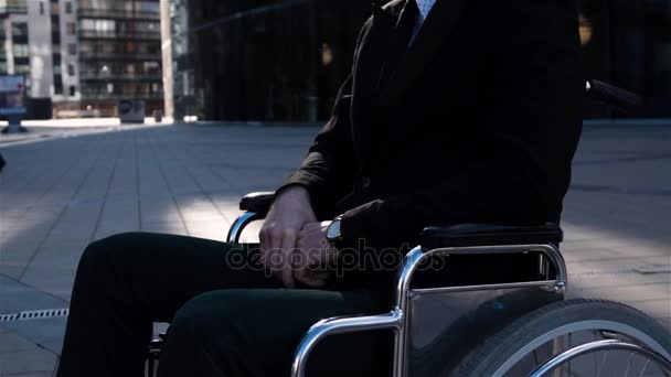 Portrait of sad handicapped businessman in wheelchair turn his head to camera outdoor — Stock Video