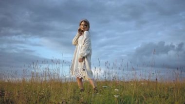 Mutlu stil sahibi kadın kırsal alanda dans ediyor.
