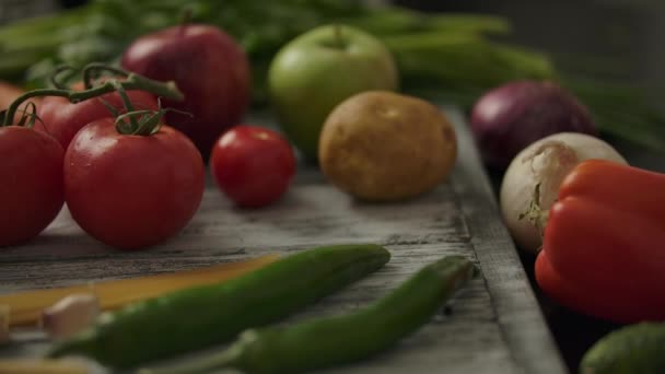 Anonymous person taking tomatoes from table — Stock Video