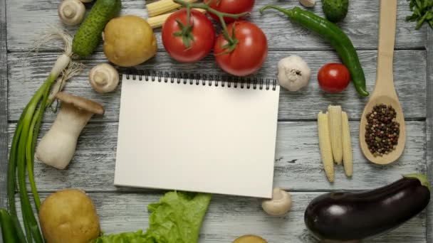 Libro de cocina tirando sobre mesa de madera con ingredientes de la receta — Vídeo de stock