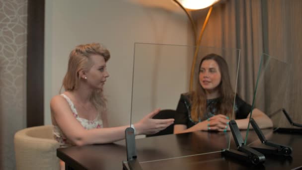 Two ladies look at two transparent displays set — Stock Video