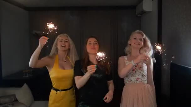 Three ladies happy dancing with sparklers. — Stock Video