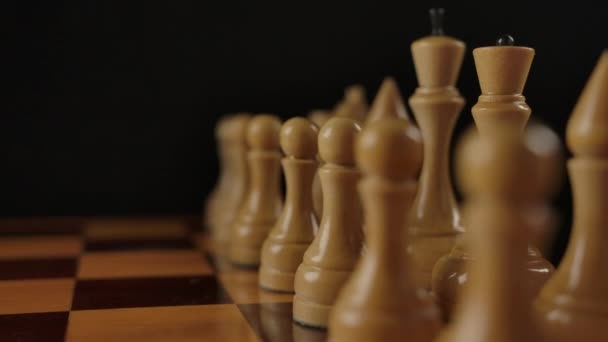 White wooden chess figures on checkerboard — Stock Video