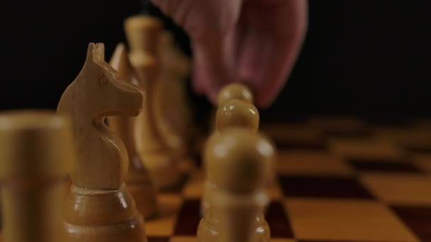 Menschliche Hand macht ersten Zug durch weißen Bauern e2 e4 im Schachspiel. — Stockvideo