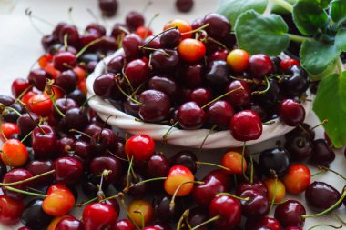Kirazlar ahşap masada, su damlaları makro arka planda..