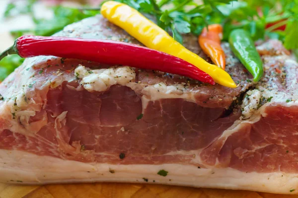 Piece of pork salted in the traditional way, along with chili. — Stock Image Piece of pork salted in the traditional way, along with chili. Stock Image