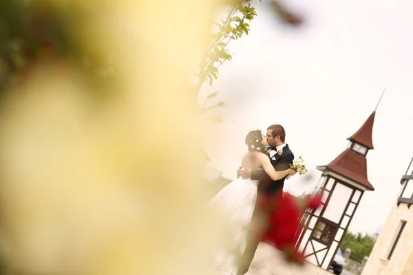 Beautiful bridal couple embracing on wedding day — Stock Photo, Image