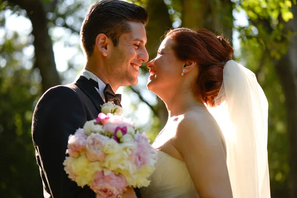 Alegre pareja nupcial abrazando al aire libre —  Fotos de Stock