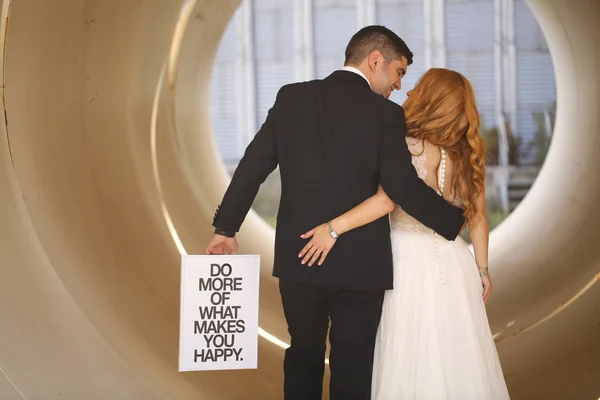 Bridal couple posing in a big pipe — Stock Photo, Image