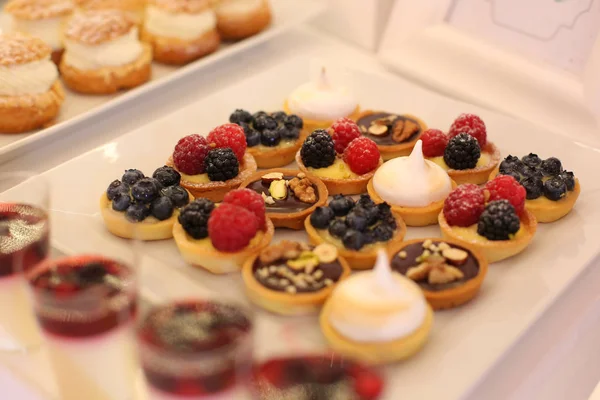 Table with delicious mini cakes — Stock Photo, Image