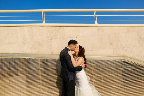 Groom and bride kissing outdoor