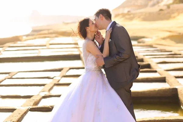 Groom and bride kissing outdoor