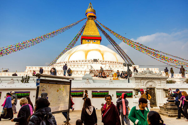 KATHMANDU, NEPAL-December 4,2018: Sacred Boudhanath buddhist stupa with Prayer flags and pilgrimage in Kathmandu. Famous Buddhist Stupa in the world