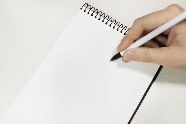 adam beyaz defter üzerinde yazar. metniniz için boşaltmak